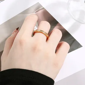 Detailed macro shot of a gold-plated stainless steel ring with inlaid cubic zirconia