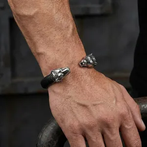 Detail view of a punk style stainless steel wolf head open cuff bracelet for men