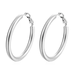 Detailed view of polished silver titanium steel hoop earrings in minimalist style