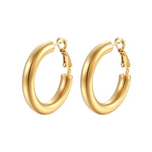 Close-up of chunky gold hoop earrings made from polished 304 titanium stainless steel