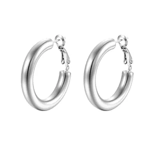 Detail view of chunky silver-colored hoop earrings in a polished stainless steel style.