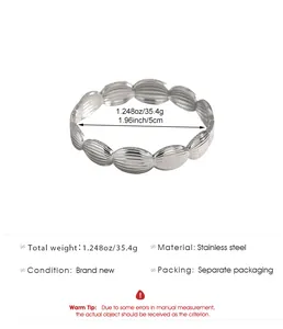 Detail view of textured stainless steel bangle showing weight and 5cm diameter specs.
