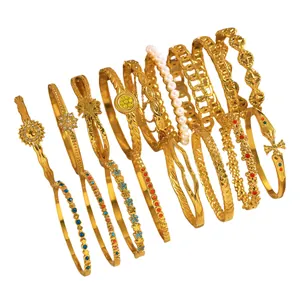 Collection of diverse gold-tone stainless steel fashion bracelets with pearl accents