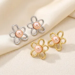 Close-up view of elegant vintage gold and silver flower earrings with pink pearls