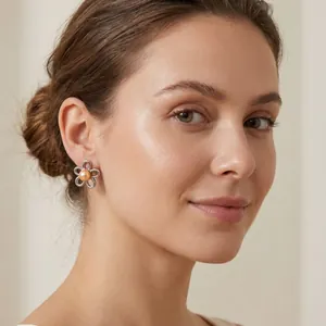 Detailed shot of French vintage flower earrings with pearl on a model's ear