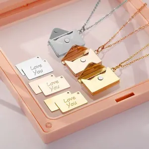 Detailed close-up of stainless steel envelope locket necklaces with Love You card