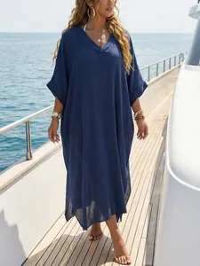 Elegant navy blue V-neck beach cover-up maxi dress with side slits on a yacht deck