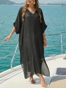 Elegant black V-neck beach cover-up dress shown on a luxury yacht deck setting