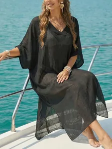 Elegant women's black semi-sheer V-neck beach cover-up maxi dress with side slits.