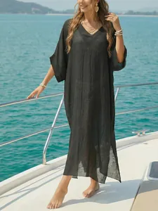 Elegant women's V-neck black beach cover-up loose maxi dress with side slits on a boat