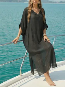 Women's V-neck loose beach cover-up long dress with side slits and airy black fabric.