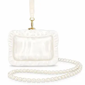 Detailed view of the pearlescent white acrylic evening clutch bag with elegant pearl strap