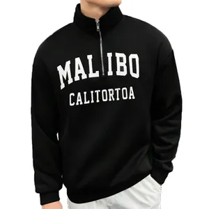 Close-up of men's vintage black half-zip sweatshirt featuring white letter print details
