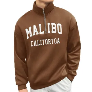 Detail of a brown men's vintage half-zip sweatshirt with white Malibu letter print.
