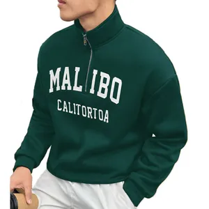 Detailed close-up of dark green men's retro half-zip sweatshirt with white MAL IBO print