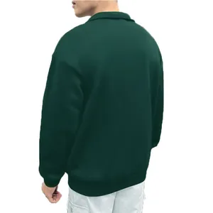 Back view of a dark green men's vintage half-zip sweatshirt in a loose fit style.