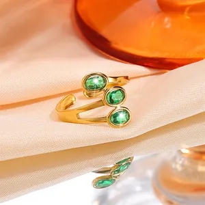 Elegant gold titanium steel adjustable ring featuring three sparkling green oval gemstones