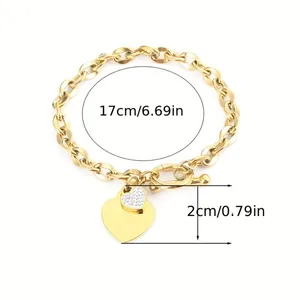 Detail view of a gold stainless steel heart charm bracelet with 17cm length measurement