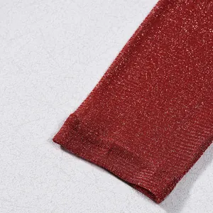 Vue macro détaillée montrant le tissu en maille rouge vin scintillant du haut à manches
