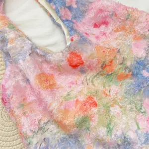 Detailed view of the soft fuzzy lace fabric with colorful floral prints on a shoulder bag