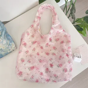 Detailed view of pink floral lace hobo bag featuring elegant textured rose patterns