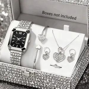 Detailed view of silver jewelry set with heart pendant and matching watch
