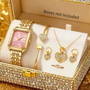 Detailed view of an elegant gold women's watch and heart-shaped rhinestone jewelry set