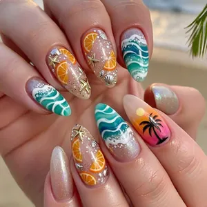 Close-up of tropical summer press-on nails with orange slices and palm tree designs