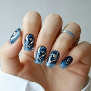 Detailed view of long blue marble press-on nails with gold leaf and heart patterns