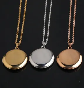 Detailed view of three round locket pendant necklaces in gold, silver, and rose gold.