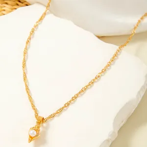 Detailed view of a vintage gold shell pendant necklace with a delicate pearl inlay