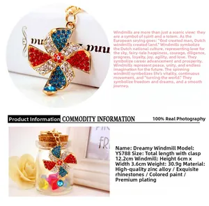 Detailed view of a vibrant rhinestone windmill keychain with gold-tone accents