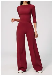Elegant burgundy high-waist yoga set with tight long-sleeve top and loose wide-leg pants