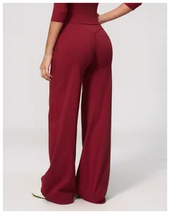 Close-up rear view of women's burgundy high-waisted wide-leg brushed yoga sports pants
