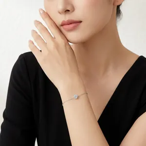 Elegant minimalist moissanite solitaire bracelet in silver worn on a woman's wrist