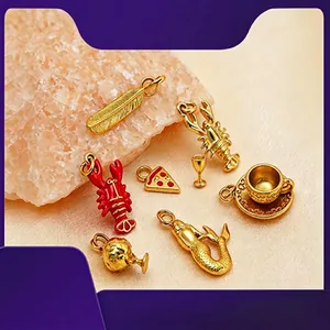 Detailed view of gold-plated stainless steel charms including lobster, pizza, and mermaid shapes