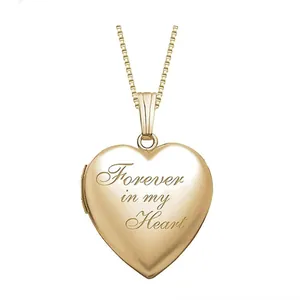 Macro view of gold stainless steel heart locket with Forever in my Heart engraving