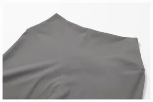 Detail view of grey high-waisted yoga pants with butt-lifting seam and brushed fabric