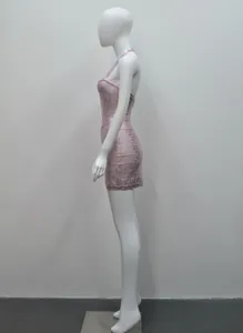 Profil latéral d'une mini-robe bandage licou rose métallisé sur un mannequin blanc