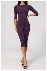Detailed view of women's purple high waist yoga capri pants and matching sports top