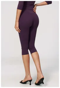 Detailed rear view of purple high-waisted brushed yoga capri pants on a model