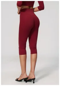 Back view of high-waist maroon yoga capris with brushed finish on female model