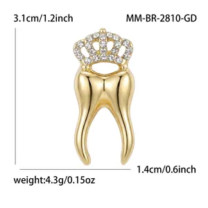 Detailed view of gold crown tooth brooch with sparkling rhinestones and measurements.