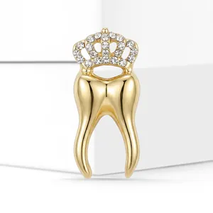 Macro view of a creative golden tooth brooch with a sparkling rhinestone crown