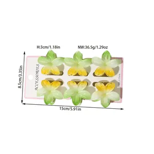 Size chart for six colorful gradient frangipani flower hair clips on a card display
