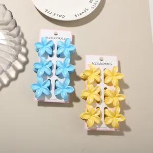 Detail view of colorful frangipani flower hair claw clips on display cards