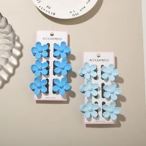 Detailed view of 12-piece blue flower hair claw clips set on display cards