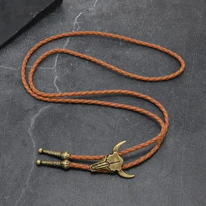 Vintage Western bull skull Bolo tie with brown braided leather cord and metal tips