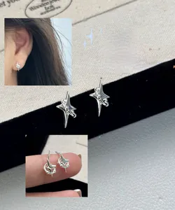 Close-up detail of S925 sterling silver minimalist cross star stud earrings for women