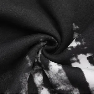Detailed macro view of black and white ink splatter print fabric texture for hoodies